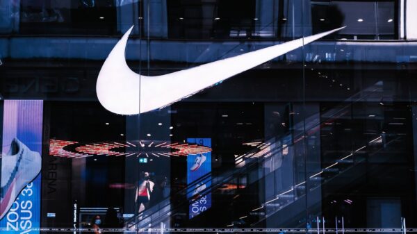 Stylish architectural facade featuring illuminated signage and glass panels, capturing a modern vibe.