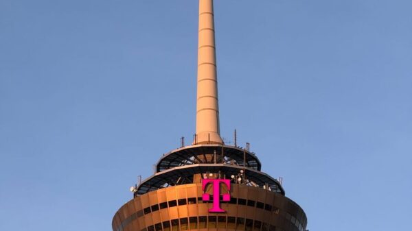 The Colonius tower in Cologne, Germany, captured at sunset against a clear sky.