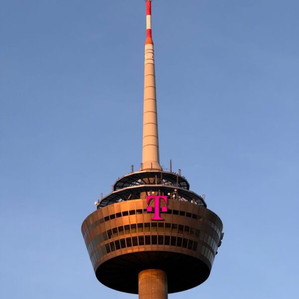 The Colonius tower in Cologne, Germany, captured at sunset against a clear sky.
