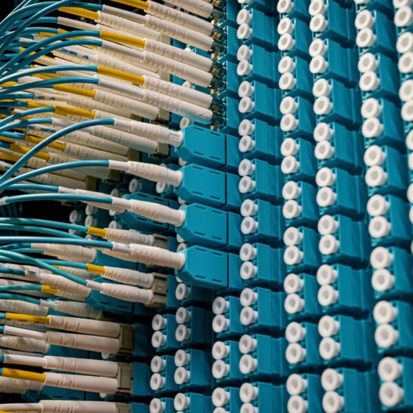 From below of fiber optic equipment with similar colorful rubber cables and round sockets