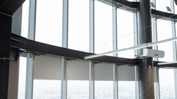 Spacious contemporary office space with employees working on laptops in a high-rise building.