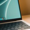 A sleek modern laptop with a close-up view of the screen and keyboard on a desk.