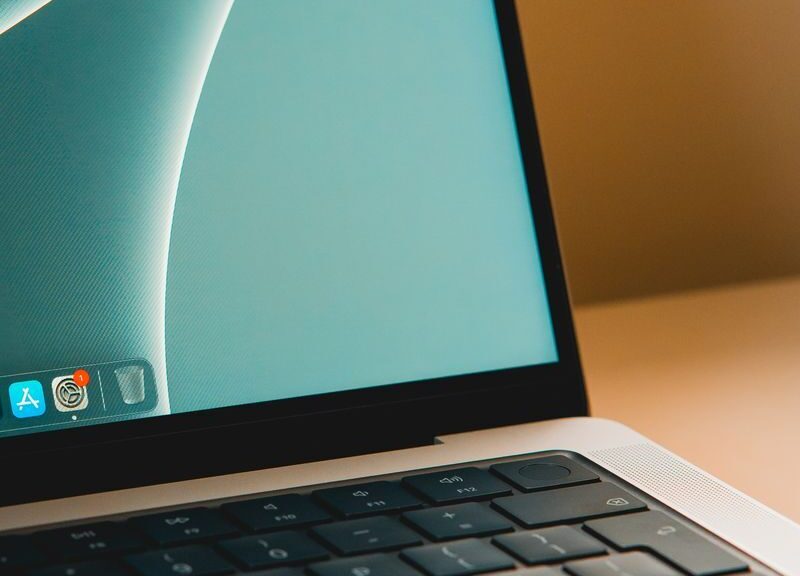 A sleek modern laptop with a close-up view of the screen and keyboard on a desk.