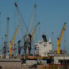 Container ship and cranes at Port Hueneme, California seaport, showcasing industrial operations.