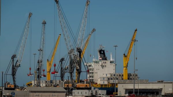 Container ship and cranes at Port Hueneme, California seaport, showcasing industrial operations.