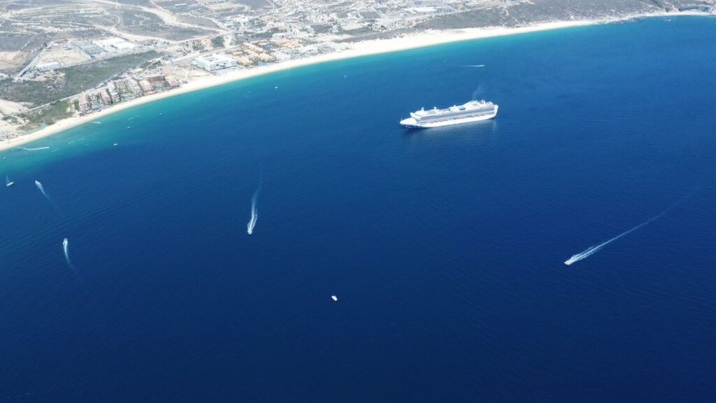 Stunning aerial view of a cruise ship sailing off the coast of Cabo San Lucas, Mexico.