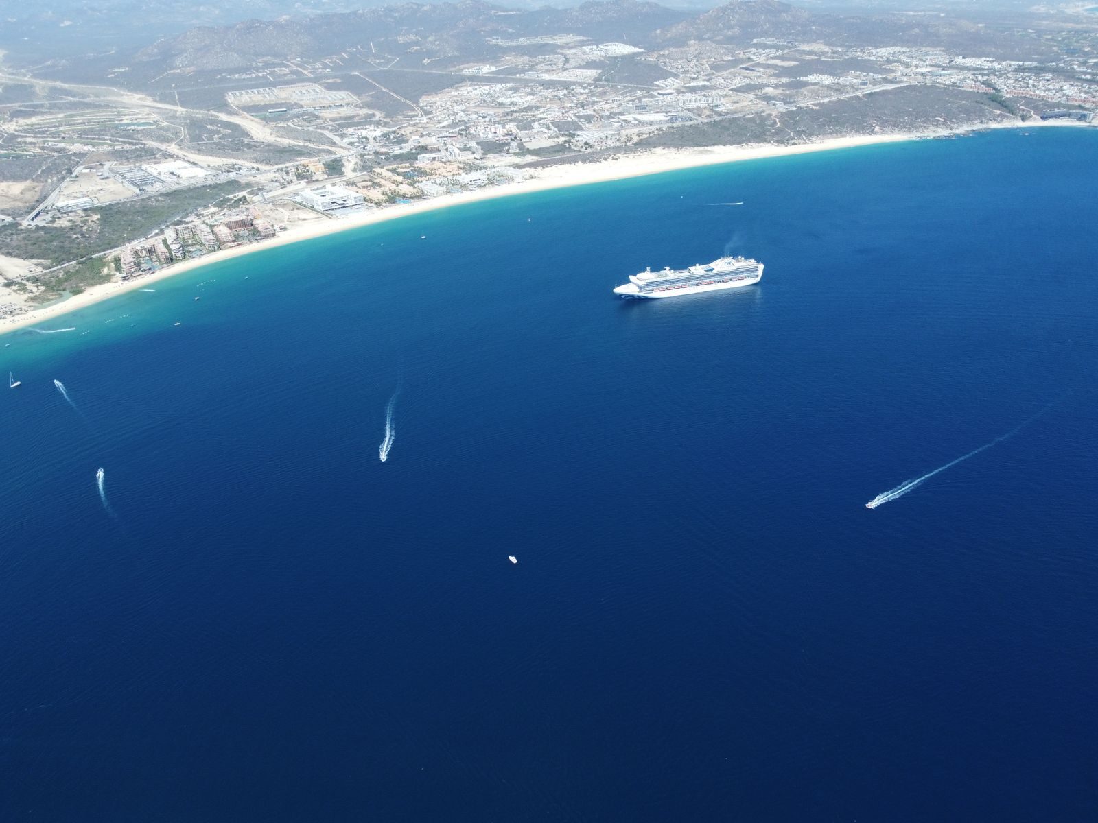 Stunning aerial view of a cruise ship sailing off the coast of Cabo San Lucas, Mexico.
