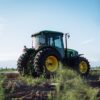 A vibrant green tractor on a farm in Mendoza, Argentina, under clear blue skies.