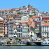 A vibrant view of the historic Ribeira District along the Douro River in Porto, Portugal.