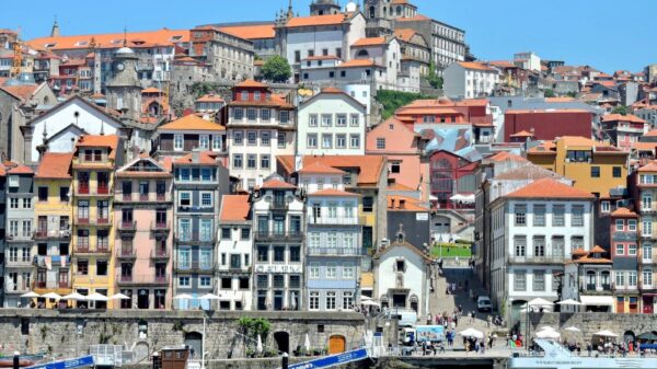 A vibrant view of the historic Ribeira District along the Douro River in Porto, Portugal.